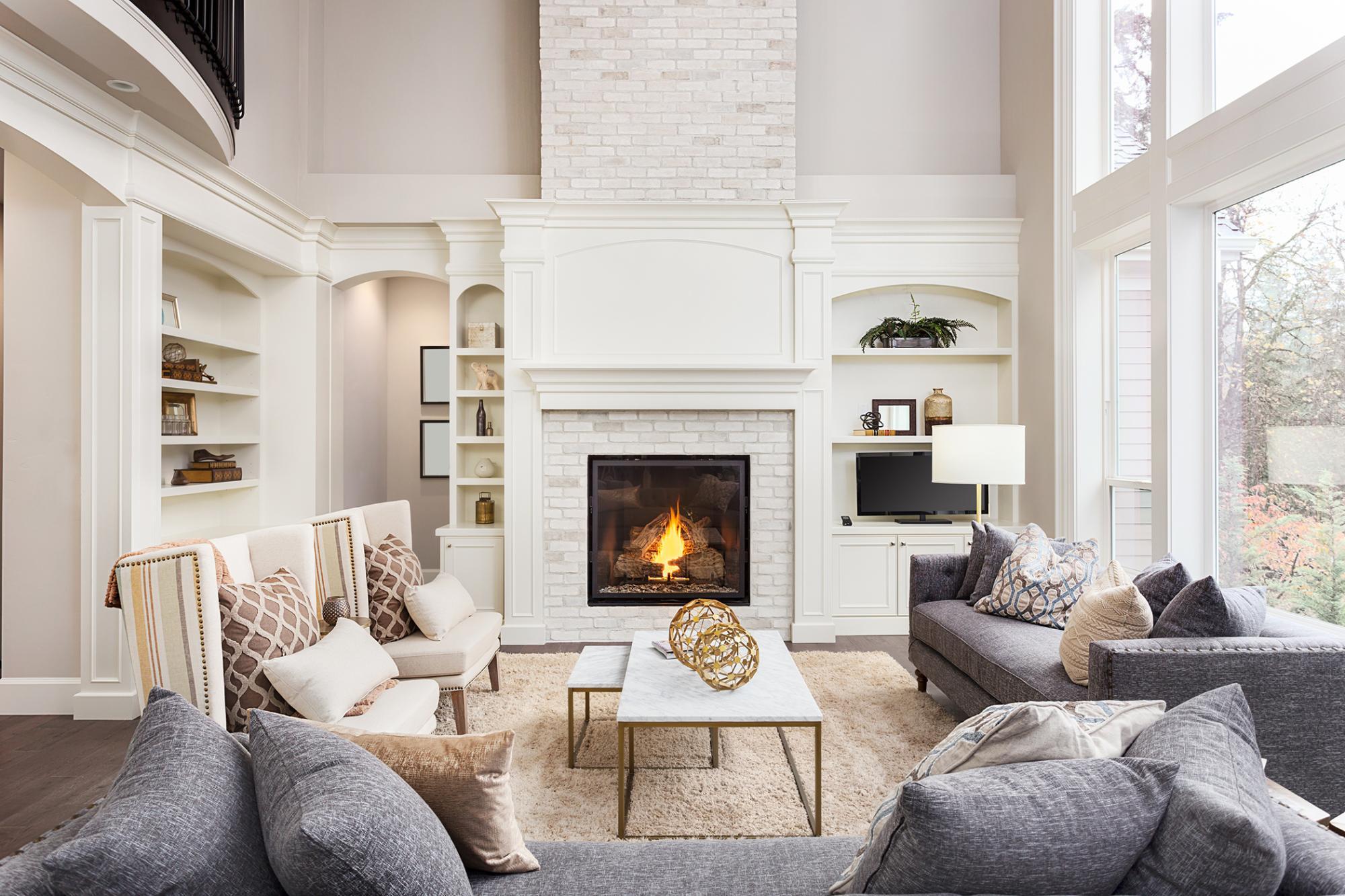 Cozy living room with comfortable couches and chairs and a fireplace in the back